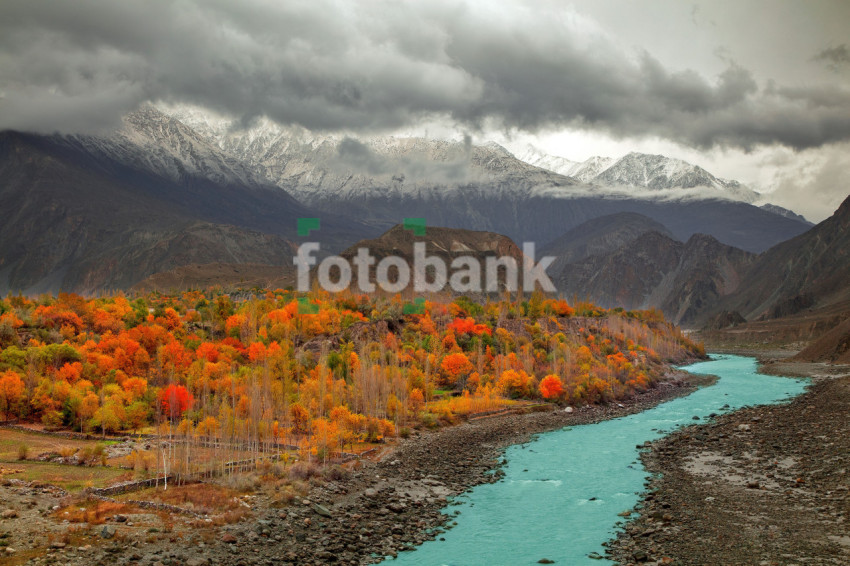 A Beautiful Natural Landscape where clouds are floating on Mountains covered in snow