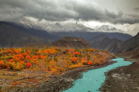 A Beautiful Natural Landscape where clouds are floating on Mountains covered in snow